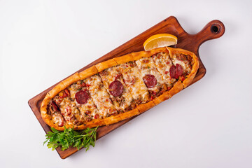 Turkish dish Pide with cheese and sausage on a white background