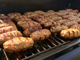 Traditional Serbian sausage links, called Cevapi, on a grill