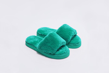Green woollen slippers on white background