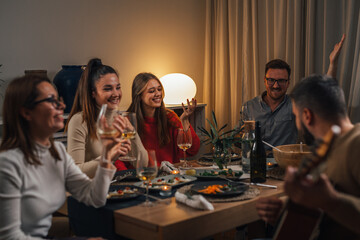 Happy friends celebrating on a dinner party