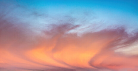 Background image of a colorful and dramatic cloudy sky at the dawn of a polar day in the Arctic. an interesting configuration of clouds. Blank for replacing the sky in photo images