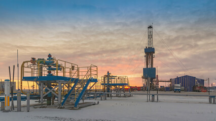 A group of gas producing wells in the Arctic field of Siberia. Polar winter day. Well equipment and...