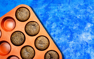 homemade chocolate nuts muffins on blue grunge background