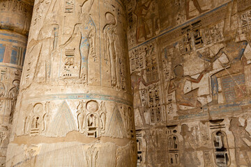 Hieroglypic painted carvings on wall at the ancient egyptian temple in Luxor. Egypt.