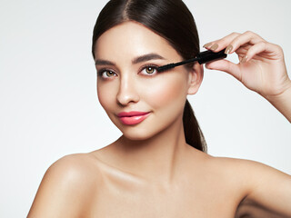 Beauty woman applying black mascara on eyelashes with makeup brush. Eyelash extensions. makeup, cosmetics. beauty, skincare