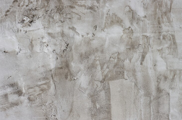 Rough dark relief stucco wall texture background.