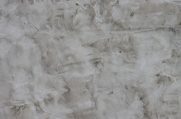 Rough dark relief stucco wall texture background.