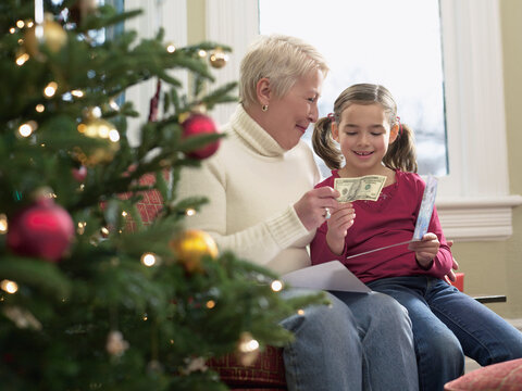 Girl Receiving Christmas Money from Grandmother