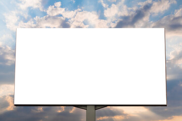 Fototapeta premium Mock up - blank white billboard against warm sunset sky - front view. Sun beams shining through dramatic clouds. Consumerism, white screen, template, copy space and mockup concept