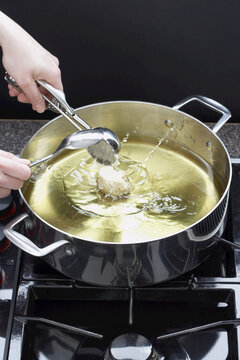 Sour Cream Doughnuts Cooking in Oil