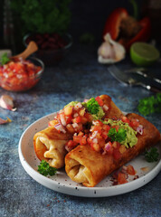 A typical dish of Mexican cuisine - Chimichanga, made of tortilla with different ingredients