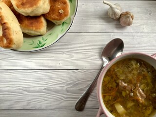 Buckwheat soup with meat and pies with garlic are prepared for lunch or breakfast