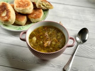 Buckwheat soup with meat and pies with garlic are prepared for lunch or breakfast