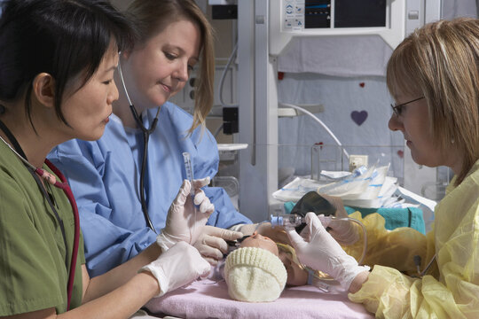Nurses Practicing on Baby Mannequin