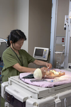 Nurse Simulating Intensive Care Work on Mannequin