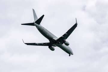 Fototapeta premium Passenger plane comes in for landing in cloudy weather.