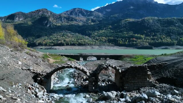 Roman bridge and sunken town of Saqu&eacute;s in the Bubal reservoir. Aerial view from a drone. Jaca Stone. Biescas Municipality. The Jacetania. Huesca, Aragon, Spain, Europe