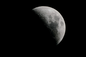 hlaf moon in front of black sky