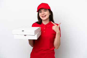 Young Russian pizza delivery picking up pizza boxes isolated on white background giving a thumbs up gesture