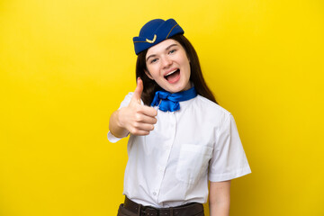 Airplane stewardess Russian woman isolated on yellow background with thumbs up because something good has happened
