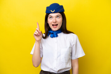 Airplane stewardess Russian woman isolated on yellow background intending to realizes the solution while lifting a finger up