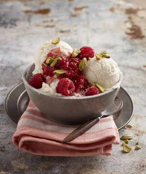 Bowl of Ice Cream with Raspberries and Pistachio Nuts, Studio Shot