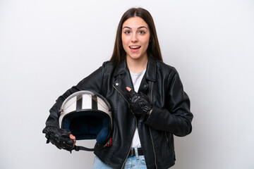 Young girl with a motorcycle helmet isolated on white background with surprise facial expression