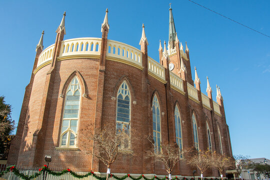 Exterior view of the St. Mary Basilica (Our Lady of Sorrows Cathedral) with semi-circular apsidal end, ornamental pinnacles, and buttresses erected in 1837 in Natchez, Mississippi, USA