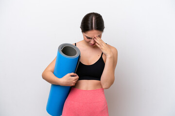 Young sport girl going to yoga classes while holding a mat isolated on white background with tired...