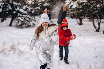 Fototapeta na wymiar Happy family having fun, playing at winter outdoors