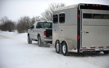 truck towing horse trailer in winter driving conditions hauling horse trailer in winter snowy...