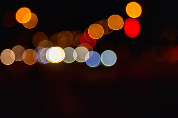 Background of night street with bokeh blurred light car and street lamps. Abstract backdrop of defocused lights at cityscape, city life. Concept of stylish urban backgrounds for design. Copy space