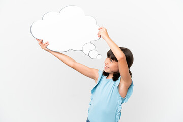 Little caucasian kid isolated on white background holding a thinking speech bubble