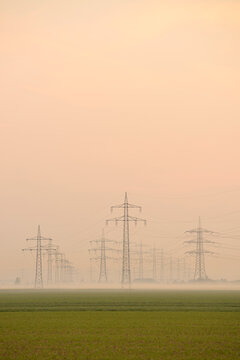 Power lines in early morning fog, Hesse, Germany, Europe