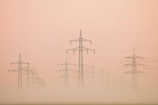 Power lines in early morning fog, Hesse, Germany, Europe