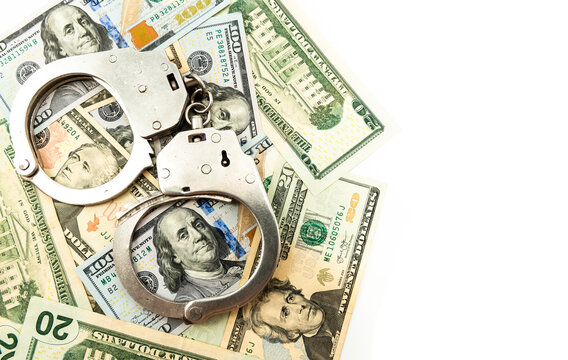 Money and handcuffs on a white background with an empty or free space for an inscription. Law
