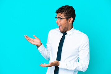 Young business Brazilian man isolated on blue background with surprise facial expression