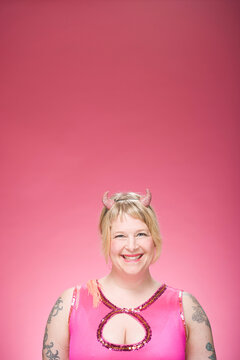 Portrait of Woman Wearing Devil Horns