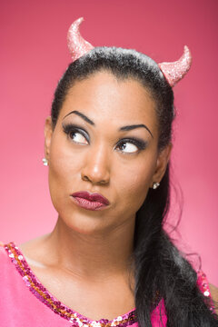 Portrait of Woman Wearing Devil Horns and Thinking