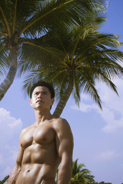 Muscular Man Outdoors in front of Palm Trees