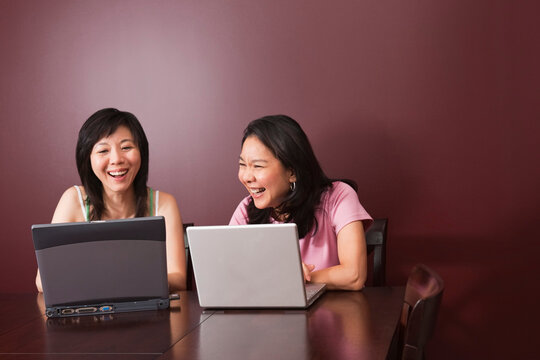 Two Women Using Laptop Computers