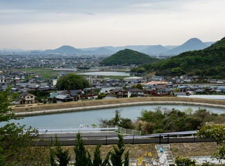 Fototapeta na wymiar Scenic view of the plains of Sanuki from the entrance to Shusshakaji, temple 73 of Shikoku pilgrimage - Zentsuji, Kagawa prefecture, Japan