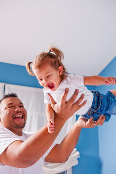 Father Lifting Daughter into the Air