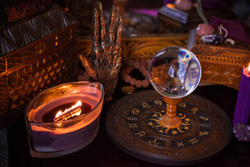 Astrology and esoteric concept. Altar with zodiac signs some stuff for horoscope, candles and mystical atmosphere