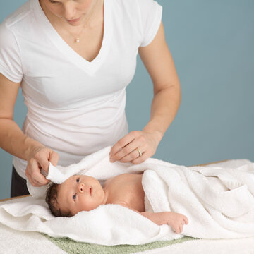 Mother Drying Newborn Baby After a Bath