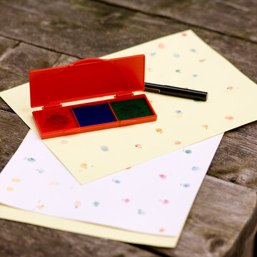 Inkpad and Paper with Stamps on Picnic Table