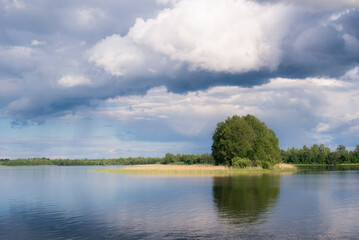Obraz na płótnie Canvas lake with clouds in summer noon