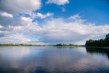 Fototapeta na wymiar lake with clouds in summer noon