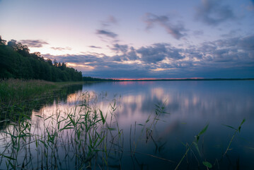 Cloudy dawn over lake in summer