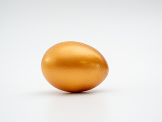 Golden eggs on a white background. Golden chicken eggs.
